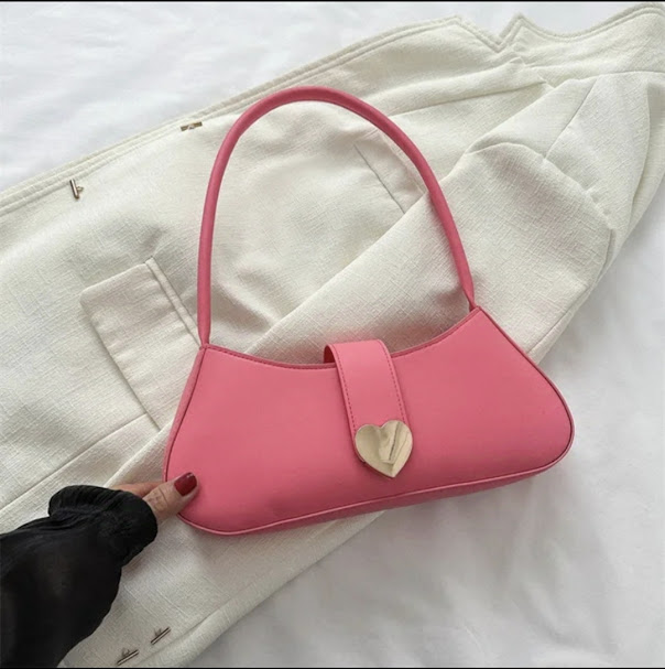 Baguette-style shoulder bag featuring a silver heart-shaped closure