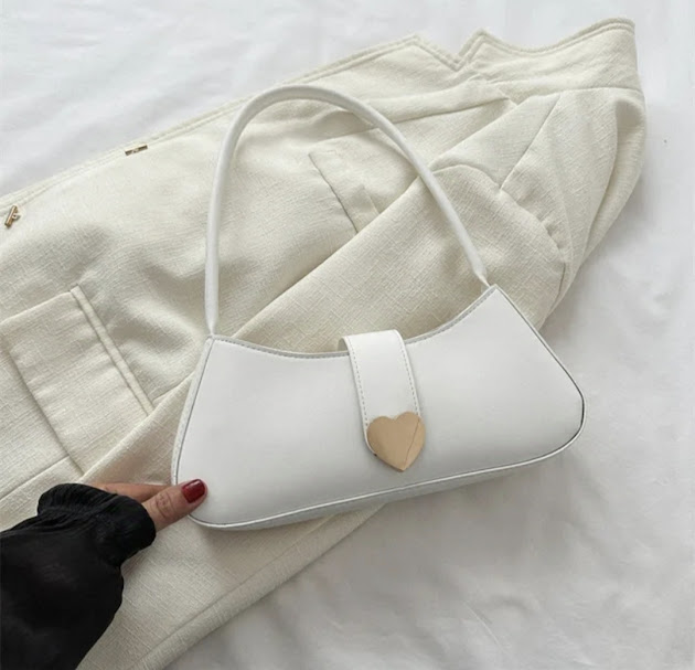 Baguette-style shoulder bag featuring a silver heart-shaped closure